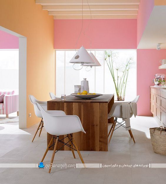 طراحی دکوراسیون آشپزخانه با رنگ های شاد و روشن مثل صورتی و نارنجی. مدل چیدمان میز جزیره یا میز ناهارخوری درآشپزخانه منزل.